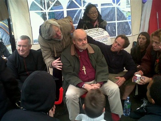 The Right Reverend Richard Chartres, Bishop of London, center, and Dean of St Paul's Cathedral, The Right Reverend Graham Knowles, left, meet a select group from the Occupy London movement in \"the tea tent\" at St Paul's before addressing protesters on the steps of the cathedral Sunday Oct. 30, 2011. The Bishop of London says anti-capitalist demonstrators camped outside the city's iconic St. Paul's Cathedral have said they will likely move on. Both the church and the local authority, the City of London Corporation, have launched legal action to seek to clear the scores of tents from a pedestrianized square and footpath outside the cathedral. (AP Photo/Arj Singh/PA Wire) UNITED KINGDOM OUT NO SALES NO ARCHIVE